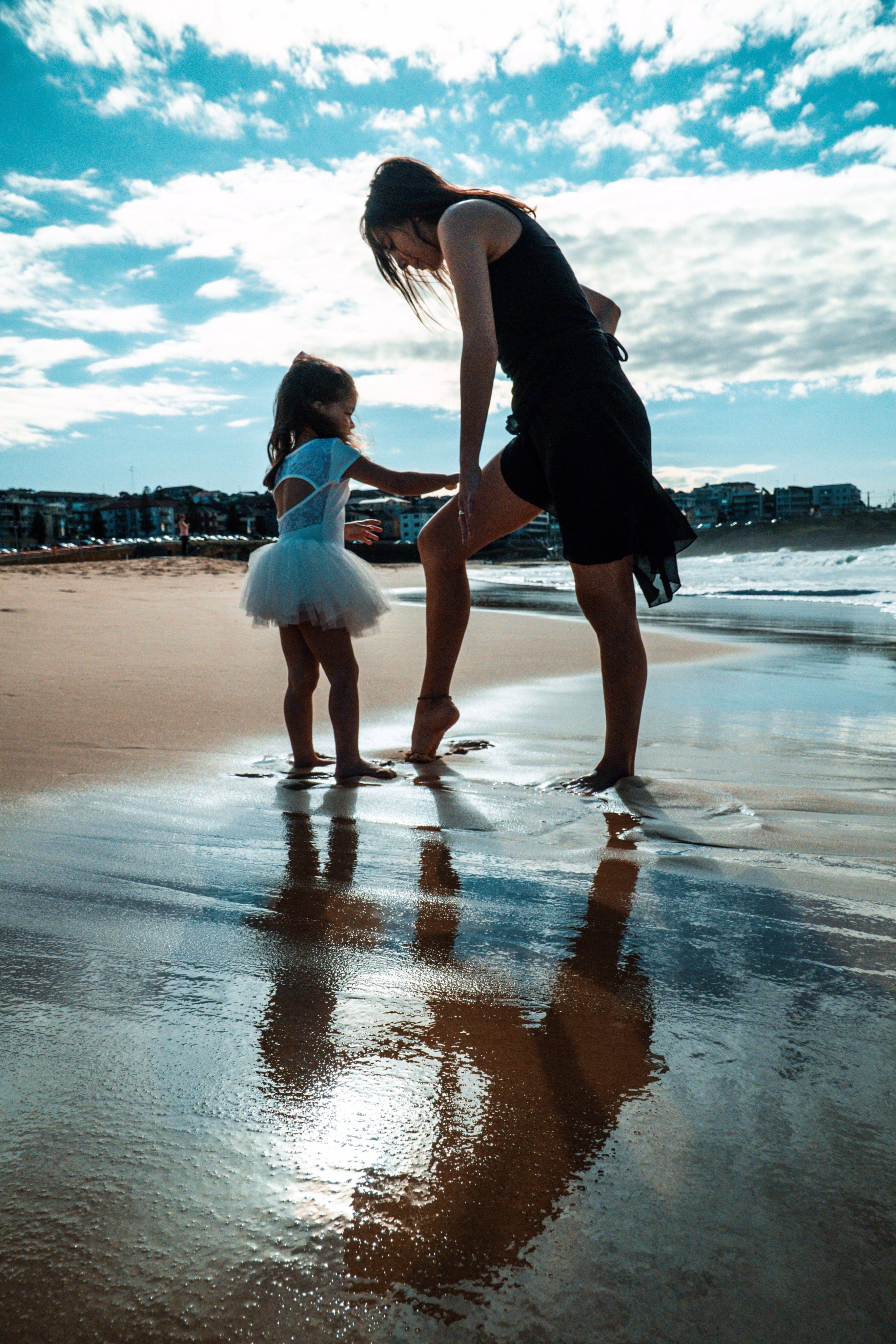 Dance teacher and ballet student at the beach